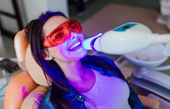 Lady’s teeth are treated with specialized light