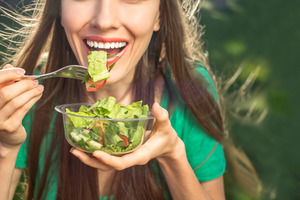 Close-up of woman eating a salad