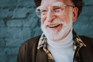 Man smiling on blue brick background